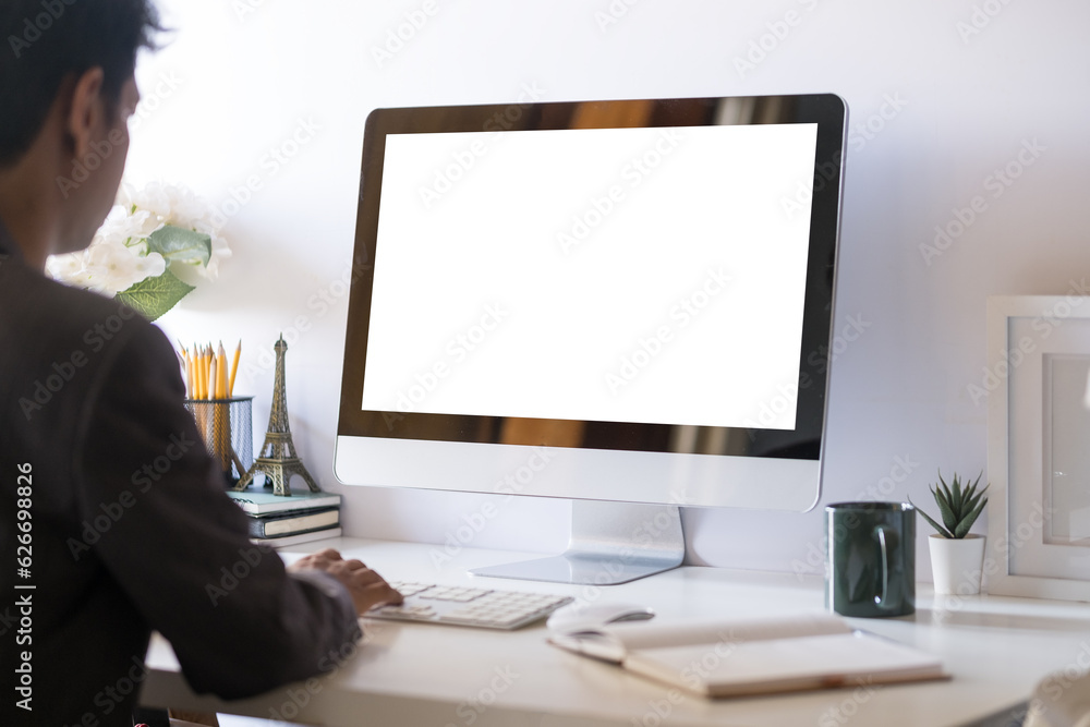 Young businessman sitting at comfortable workplace and using computer. Young businessman sitting at comfortable workplace and using computer.