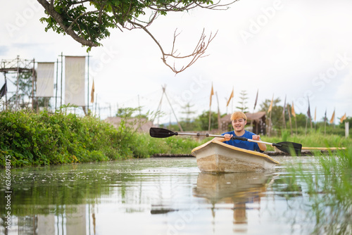 Smiling man tourists rowing boat  on the river.ravel  vacation holiday and outdoor activity.