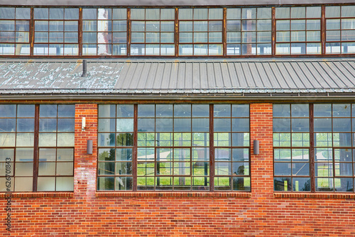 Abandoned glass factory at Ariel Foundation Park with intact windows and red brick walls exterior