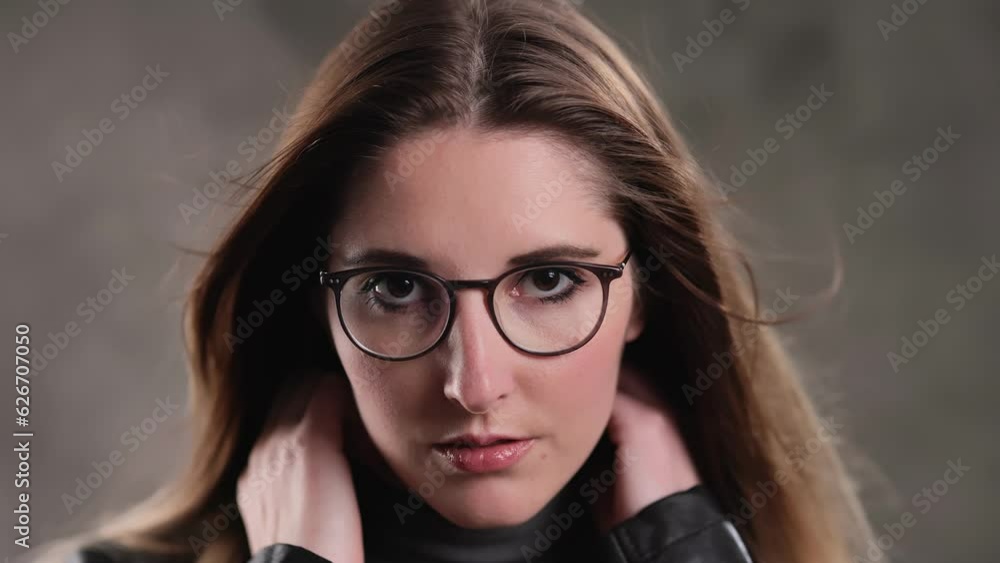 Close up of a blonde girl with a beautiful face - posing for the camera in a studio - extreme slow motion shot Close up of a blonde girl with a beautiful face - posing for the camera in a studio - extreme slow motion shot
