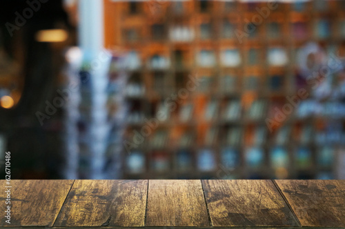 Empty dark wooden table in front of abstract blurred boken bankground of restaurant. Can used for display or montage your products. Mock up for space. photo