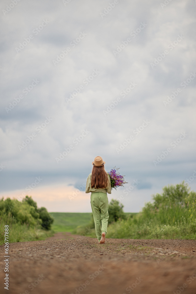 child girl with a bouquet of flowers goes along the road child girl with a bouquet of flowers goes along the road
