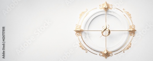 a white clock with gold accents on a white wall