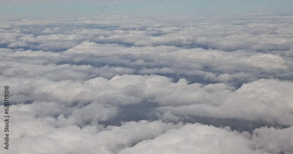 Views of beautiful from an airplane window over beautiful blue fluffy clouds make for gorgeous of green landscape Views of beautiful from an airplane window over beautiful blue fluffy clouds make for gorgeous of green landscape
