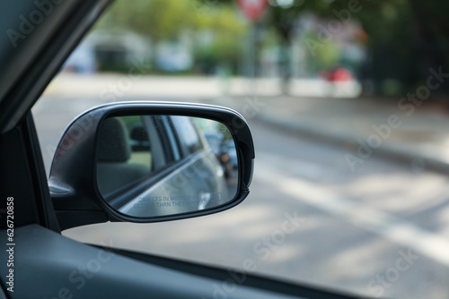 Car mirror reflects life's journey, symbolizing reflection, hindsight, self-awareness, and the road ahead. Metaphor for introspection © Your Hand Please