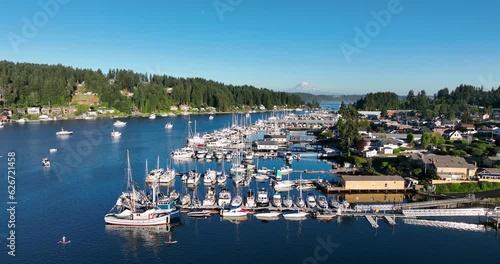 Panoramic view of the marina in Gig Harbor Washington with sail and fishing boats, mt rainier in the background