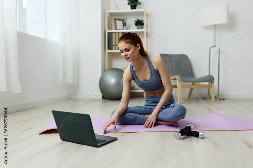 lifestyle woman exercise video health laptop training lotus mat yoga home
