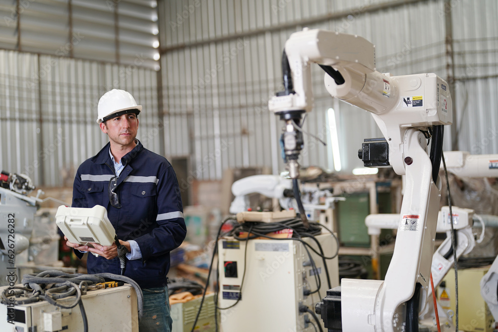 Multiracial industrial engineers working at automated AI robotic production factory, New industrial technology concept. Multiracial industrial engineers working at automated AI robotic production factory, New industrial technology concept.
