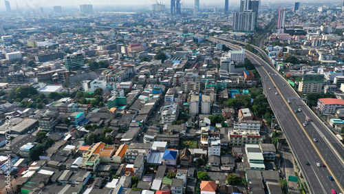 Aerial view of Bangkok city with highway, small and tall buildings