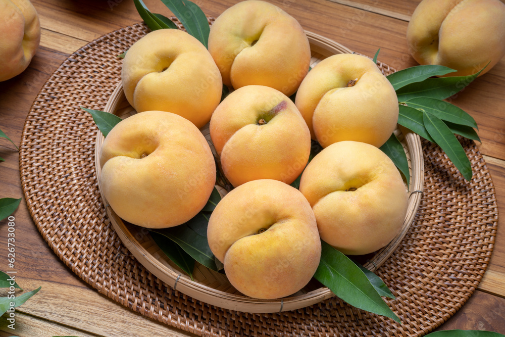 Yellow Peach on wooden basket, Peach with leaf on wooden background. Yellow Peach on wooden basket, Peach with leaf on wooden background.