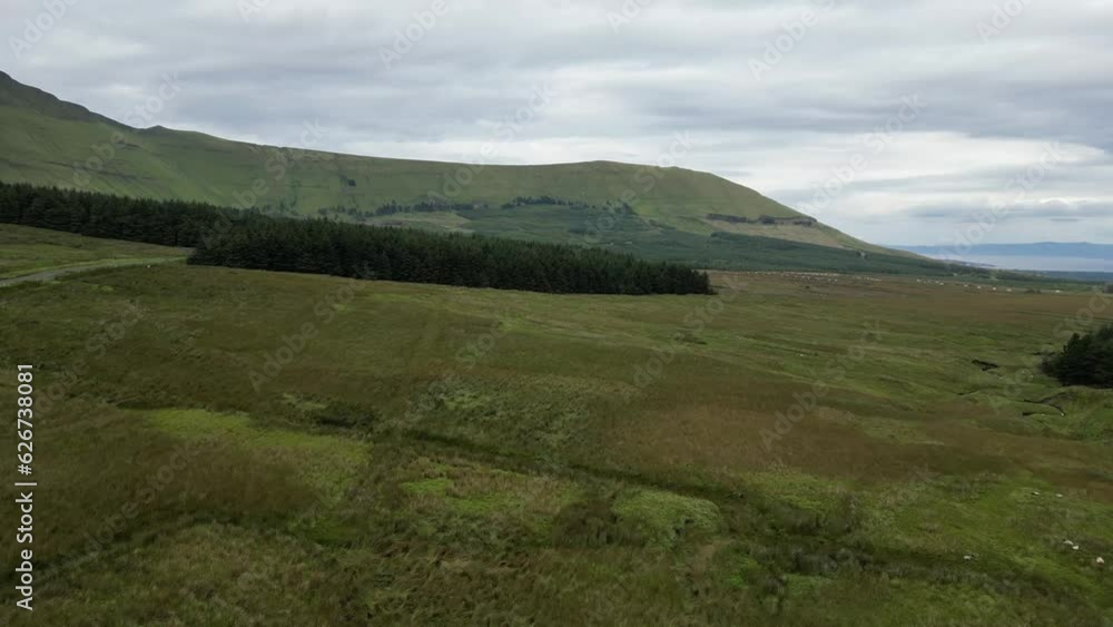 Drone shot flying over the Irish farmland with Glenniff Horseshoe in the background. Drone shot flying over the Irish farmland with Glenniff Horseshoe in the background.