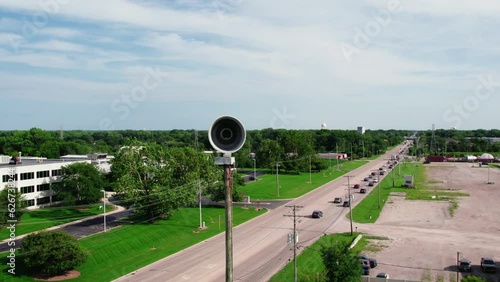 orbiting aerial Emergency natural disaster Siren. Seek shelter when activated. Horn pole for population of the city about emergency situations. Plainfield Illinois USA - Drone Aerial 4k photo
