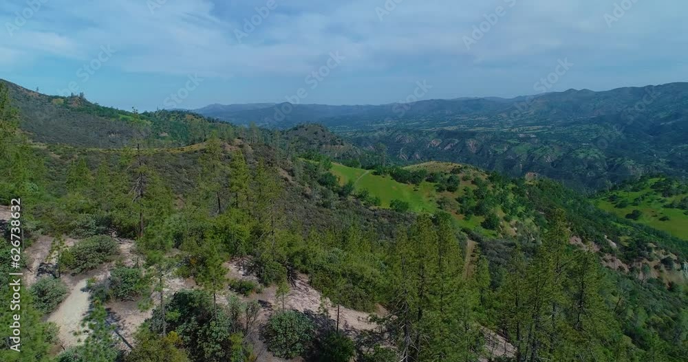 4k 29 FPS drone shot where the vast land is revealed as the drone passes over a hill. This is a push forward shot. 4k 29 FPS drone shot where the vast land is revealed as the drone passes over a hill. This is a push forward shot.