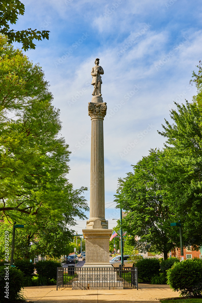 Vertical of soldier statue atop tall Greek pillar in Public Square park in downtown Mount Vernon