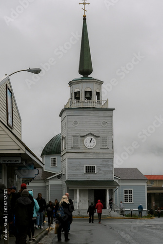 Street city view with wooden houses, shops, cars and mountain wilderness nature in Sitka, Alaska, popular cruise destination for whale watching and wildlife tours Baranof Island photo