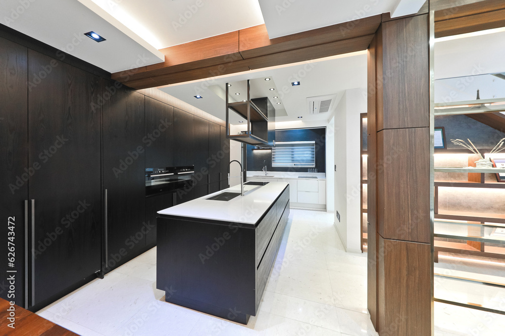 A modern kitchen interior design was created by placing the sink in the center A modern kitchen interior design was created by placing the sink in the center
