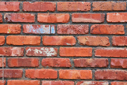Horizontal red bricks on wall with fading color and blue and white splatter background asset