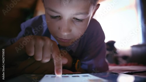 Dreamy Digital Exploration: Boy's Serene Tablet Experience on Bed