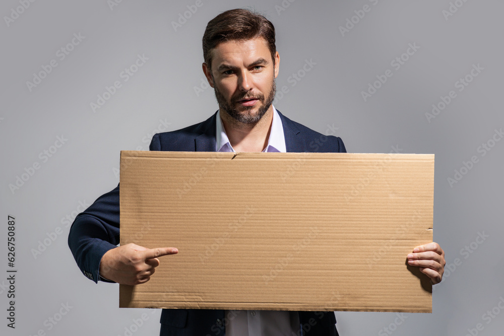 Handsome man holding empty board and pointing finger on board. Guy showing blank board with copyspace. Idea and offer. Your advertisement. Blank advertising board with empty space for text, mockup. Handsome man holding empty board and pointing finger on board. Guy showing blank board with copyspace. Idea and offer. Your advertisement. Blank advertising board with empty space for text, mockup.