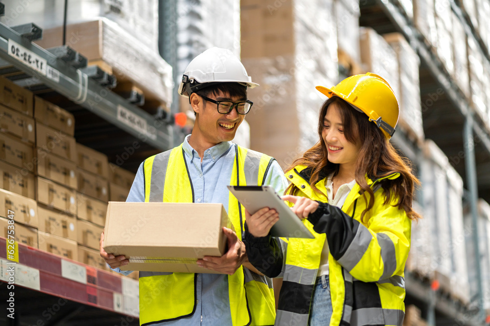 Asian two engineer team shipping order detail on tablet check goods and supplies on shelves with goods background inventory in factory warehouse.logistic industry and business export Asian two engineer team shipping order detail on tablet check goods and supplies on shelves with goods background inventory in factory warehouse.logistic industry and business export