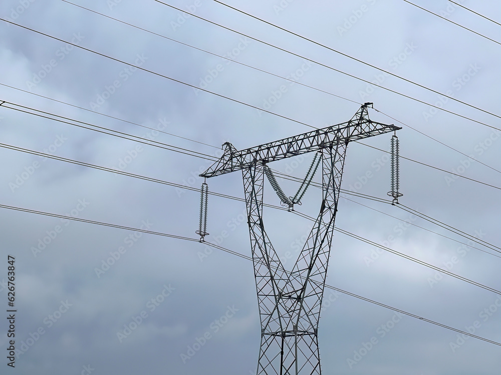Power transmission line. Industrial background. Power pylons of an overhead line Power transmission line. Industrial background. Power pylons of an overhead line