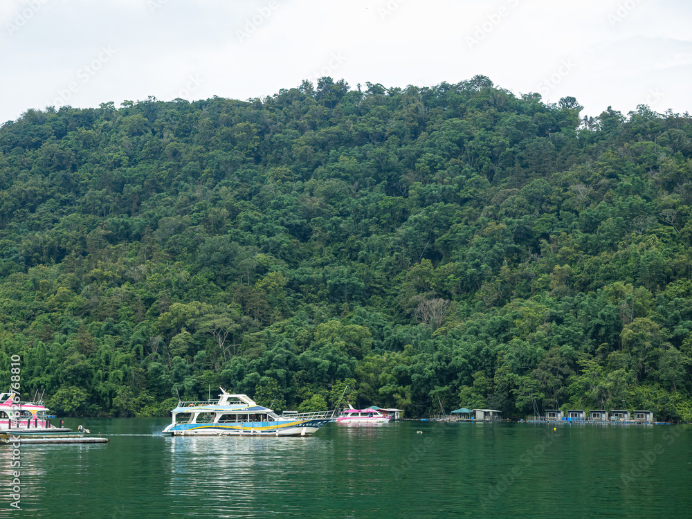 SUN MOON LAKE,TAIWAN - JUNE 10: many boats parking at the pier on June 10, 2023 at Sun Moon Lake, Taiwan. Sun Moon Lake is the largest body of water in Taiwan as well as a tourist attraction.