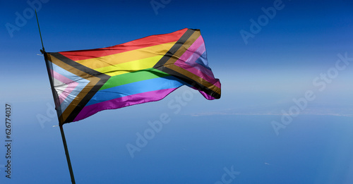 Bi Inclusive Unity flag waving in the wind at cloudy sky. Freedom and love concept. Pride month. activism, community and freedom Concept. Copy space
