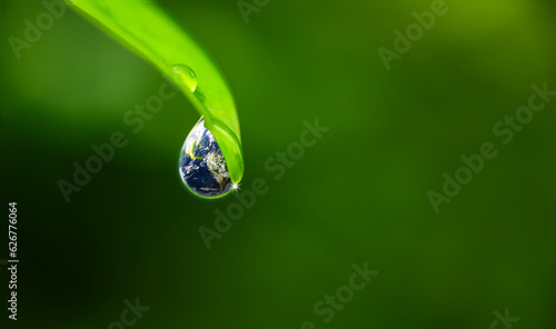 Fototapeta Naklejka Na Ścianę i Meble -  world water day. a globe in the shape of a drop of water falling onto the green leaf. Elements of this image furnished by NASA