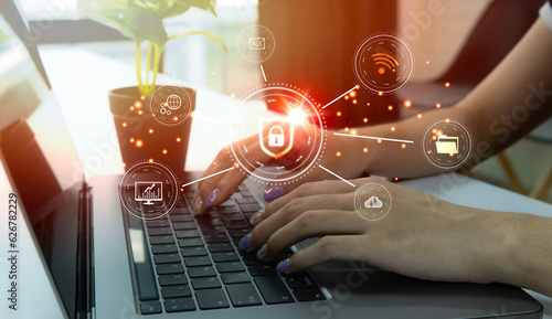 Woman working on laptop computer. Cyber security or cybercrime attack and threats to the Internet personal concepts. lock icon on virtual screen.