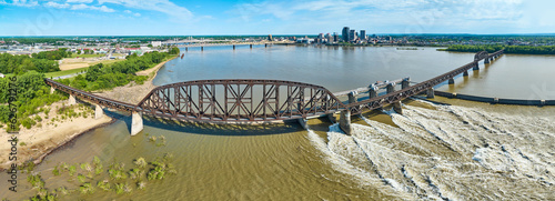 Panoramic railroad bridge next to Ohio River dam distant bridges and Louisville KY aerial