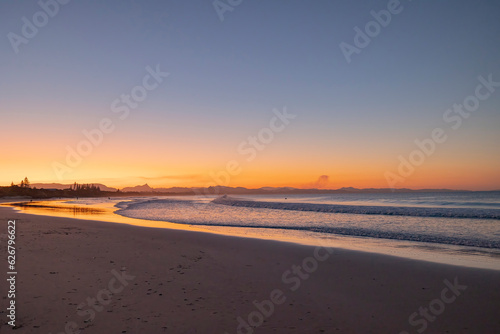 Fototapeta Naklejka Na Ścianę i Meble -  Sunset beach views across Main Beach in Byron Bay, New South Wales, Eastern Australia