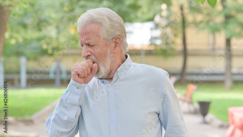 Outdoor Portrait of Senior Old Man Coughing photo