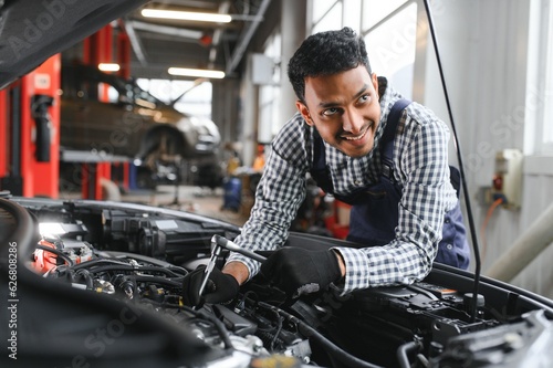 Indian happy auto mechanic in blue suit.