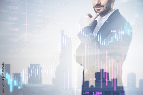 Successful businessman silhouette using forex chart hologram on blurry city background with mock up city view. Future and financial freedom concept. Double exposure.