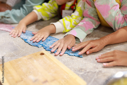 cooking a dish of colored dough by children in the kitchen