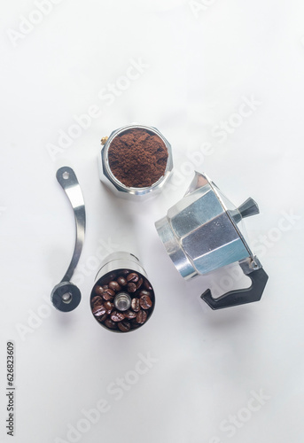 Moka pot, coffee maker with coffee bean around isolated on white background.