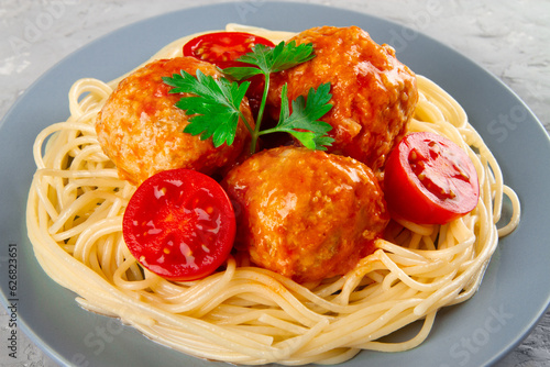 Delicious meatballs made from turkey in spicy tomato sauce served with pasta, close-up