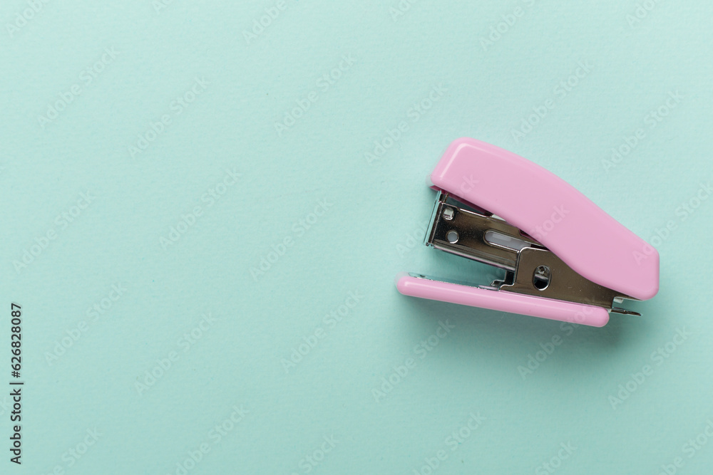 Pink stapler on color backgroung, top view Pink stapler on color backgroung, top view