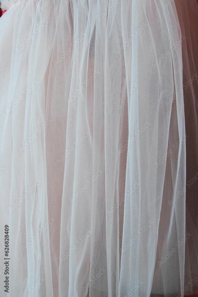Fabric or a fragment of a dress for a woman. Chiffon fabric with pleats. Fabric or a fragment of a dress for a woman. Chiffon fabric with pleats.