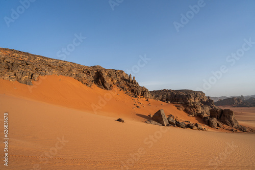 view in the Sahara desert of Tadrart rouge tassili najer in Djanet City ,Algeria.colorful orange sand, rocky mountains