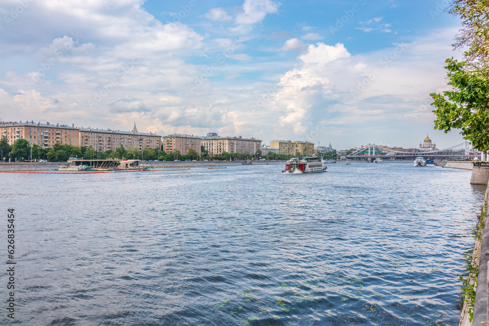 Cruise ship sails on the Moscow river in Moscow city center, popular place for walking. Cruise ship sails on the Moscow river in Moscow city center, popular place for walking.