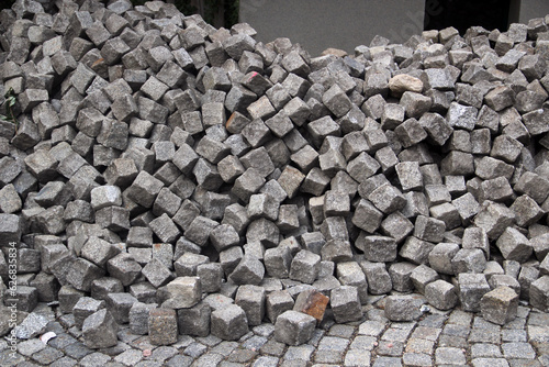 Pile of cobblestones on a pavement, a construction background