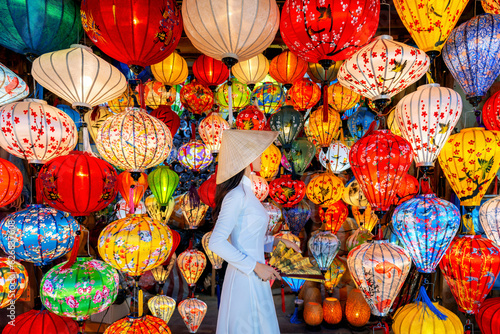 Asian woman wearing vietnam culture traditional and hoi an lanterns at Hoi An ancient town, Vietnam. photo