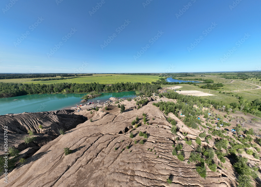 panoramic view of the high hills of the lake with turquoise water and green forest from the reserve in the Tula region taken from a drone