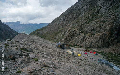 Ak-Sai Racek Hut and Glacier basecamp. Tents of mountain climbers. Ala Archa Alpine National Park Landscape near Bishkek, Tian Shan Mountain Range, Kyrgyzstan, Central Asia