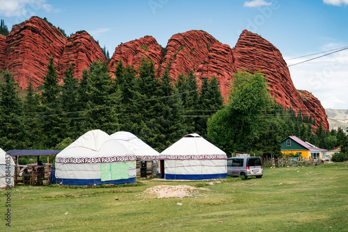 White yurts stand at the foot of the mountain. Mountain gorge Jety Oguz. Kyrgyzstan's picturesque destination. Travel photo 