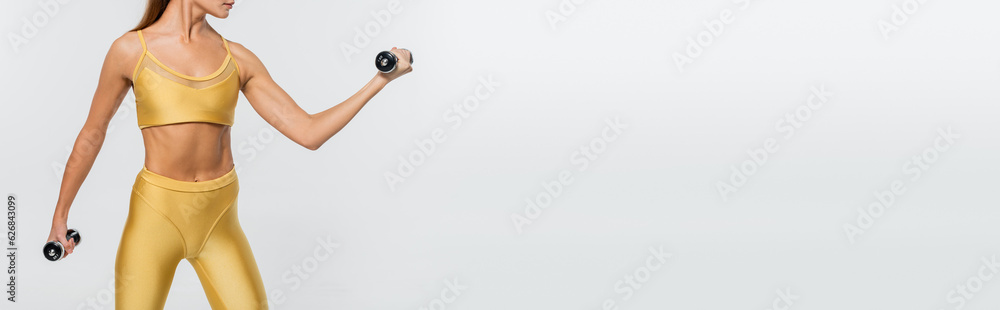 woman in active wear, exercising with dumbbells, white background, motivation, toned body, banner
