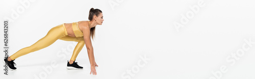 fit sportswoman in sneakers training on white background, banner, physical activity concept, banner