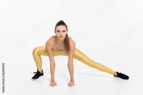 fit sportswoman in active clothes working out on white background, physical activity concept