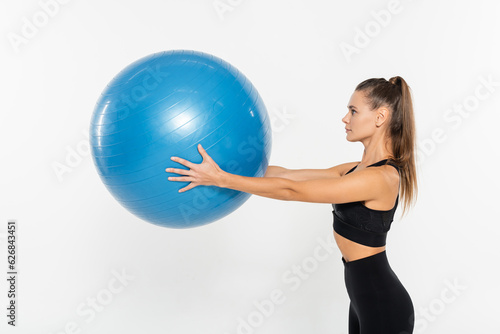 fit woman in active wear holding fitness ball isolated on white, athletic woman concept